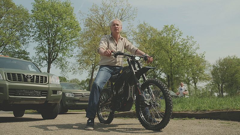 Protect Ukraine co-founder Jaap Scholten on a donated electric motorcycle, designed for silent frontline mobility.